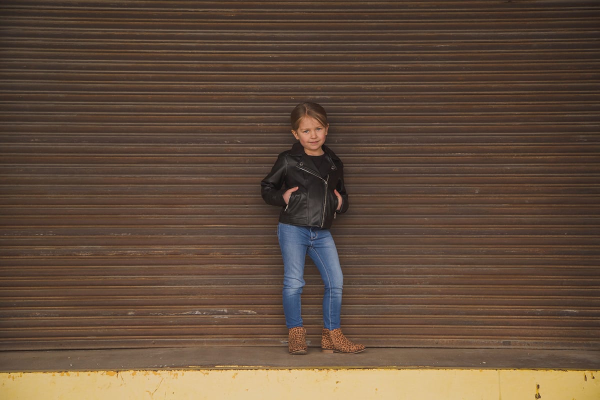 sassy young girl posing in a leather jacket