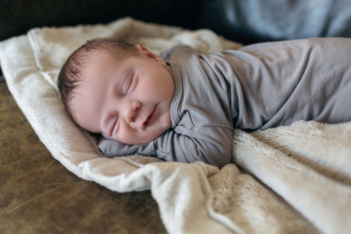 smiling-sleeping-newborn-boy