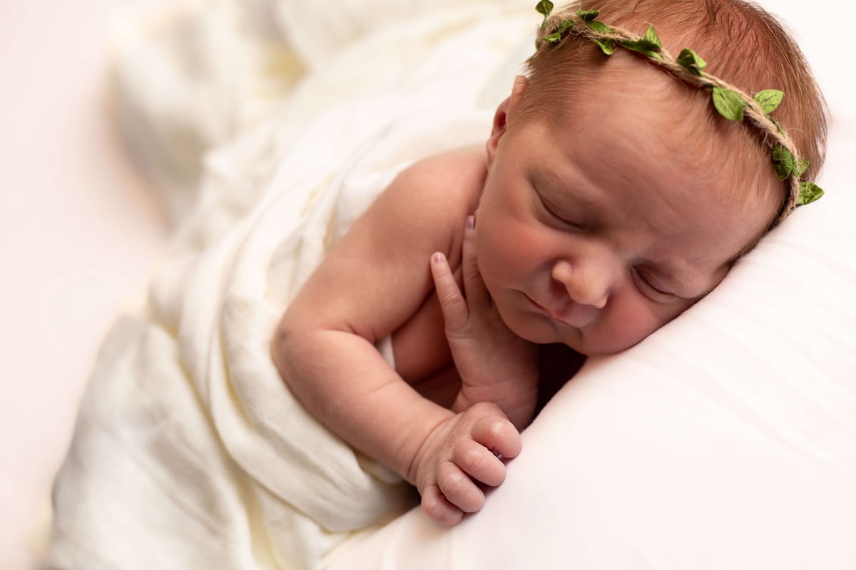 sleeping newborn baby with flower crown